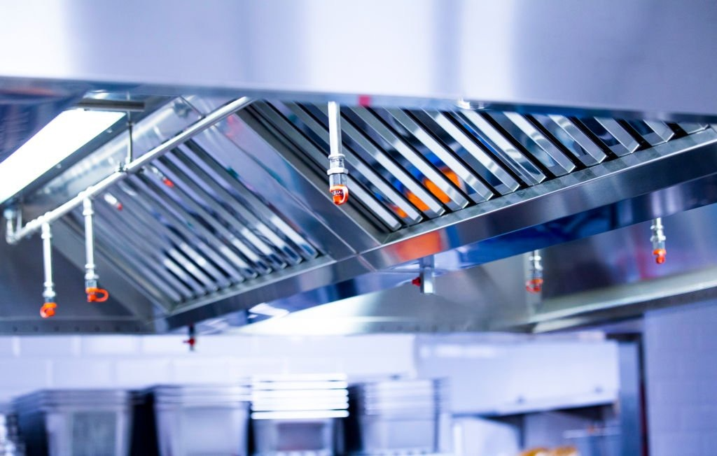 Automatic Kitchen Hood Fire Suppression System protecting a commercial kitchen from grease fires.